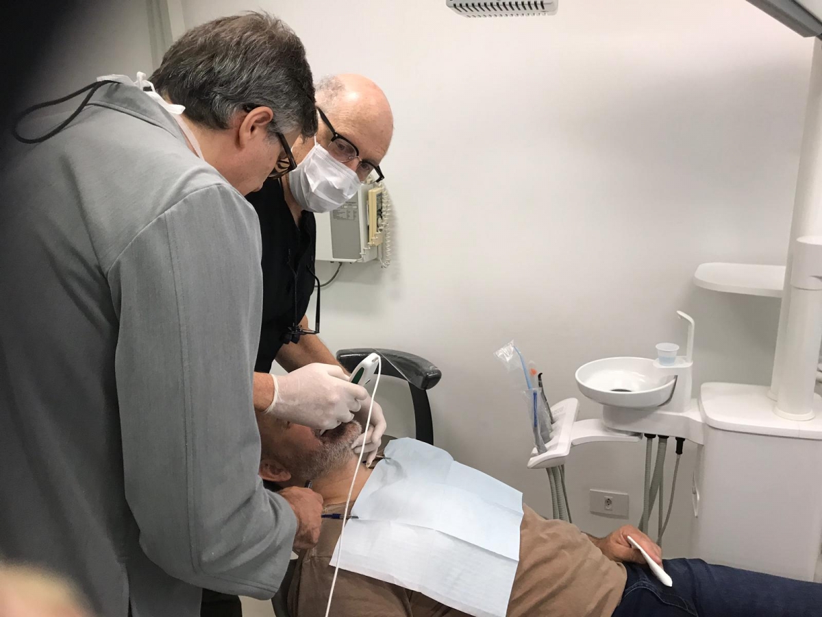 Dr. Scott Green using T-Scan to analyze a patient’s occlusion with Dr. Marcelo Calamita