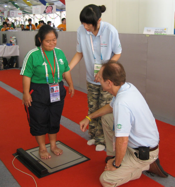 An Athlete's feet are assessed with the MatScan at the Special Olympics.