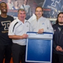 Norman Murphy of Tekscan with the Sports Program Director at Cégep de Thetford and two football players holding the MobileMat.